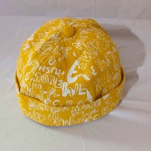 Vintage yellow brimless hat with rolled cuff and adjustable strap